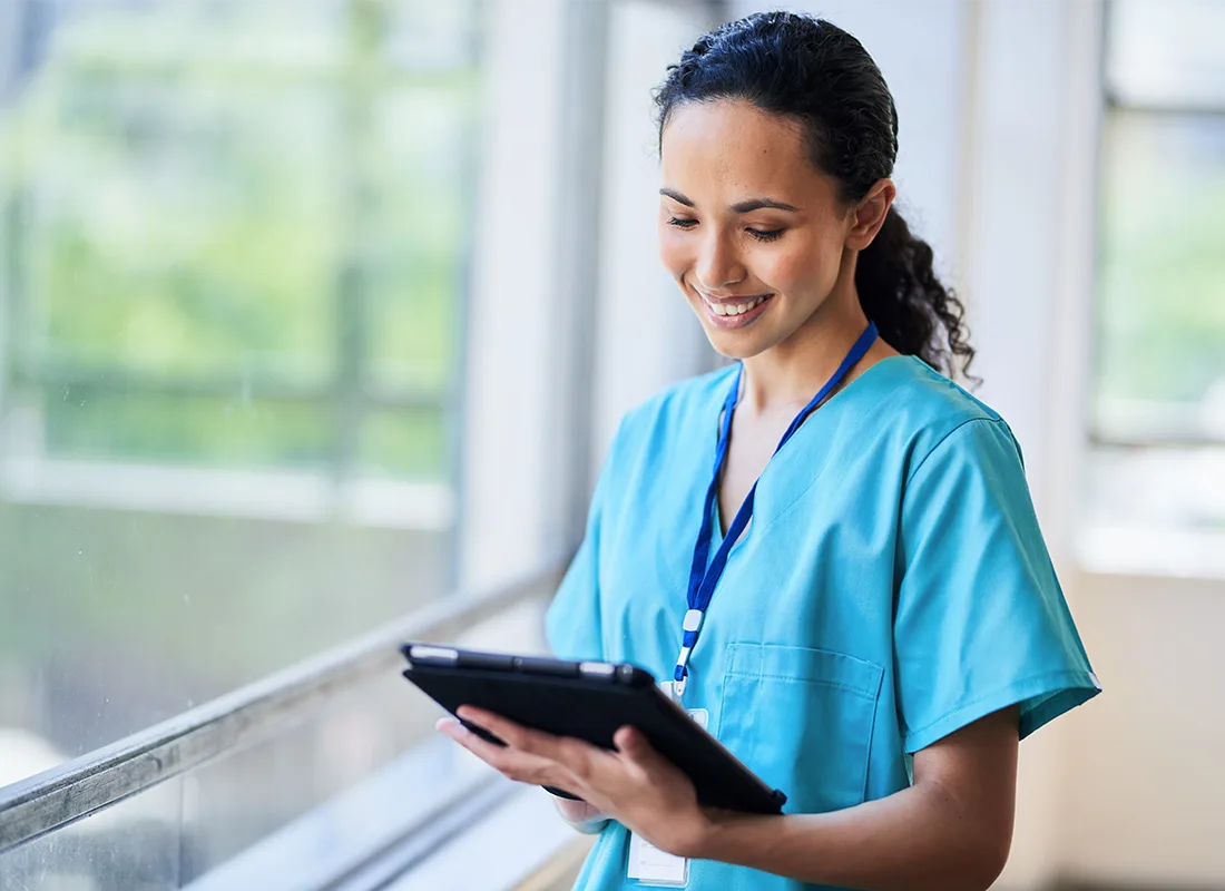 smiling-nurse-hospital-scrubs-using-digital