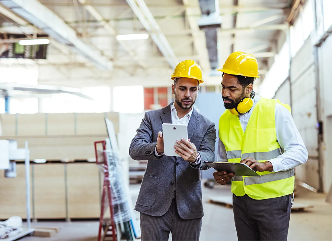 two-professionals-wearing-safety-gear-analyze.