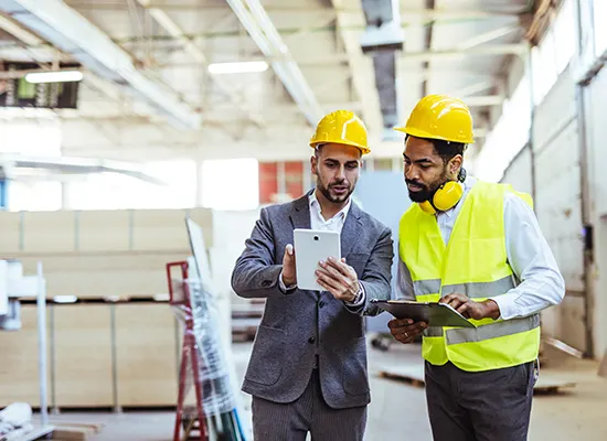 two-professionals-wearing-safety-gear-analyze.